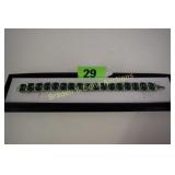 LADIES STERLING SILVER AND EMERALD BRACELET.