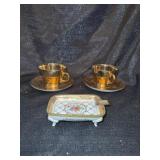 Gold colored cups and saucers
