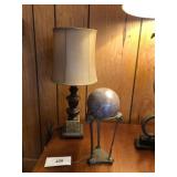 Lamp and brass stand with marble like sphere.