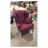RED UPHOLSTED ARM CHAIR WITH PILLOW
