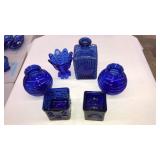 4 COBALT BLUE GLASS VASES & 2 CANDLE VOTIVES