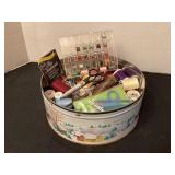 Tin of sewing notions, scissors, etc.