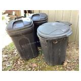 3 trash cans, one has some extension cords in it.