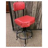 Red rolling, swivel shop stool