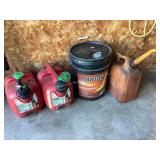 3 gas cans & partial bucket of hydraulic fluid