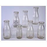 7 NC Embossed Round Clear Glass Milk Bottles