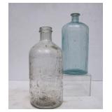 2 Vintage Embossed Half Gallon Bottles