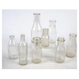 8 Embossed Round Milk Bottles