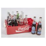 Various Soda Bottles, Some Filled, in Coke Crate