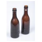 2 Koka Nola Brown Straight Side Embossed Bottles