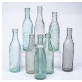 8 NC Straight Side Embossed Bottles