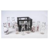 9 Cream Top Milk Bottles in Gray Plastic Crate