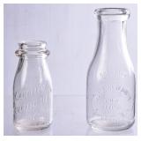 2 NC Embossed Round Milk Bottles