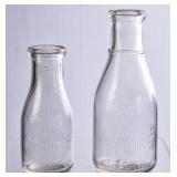 2 NC Embossed Round Clear Milk Bottles