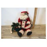 Santa Dressed In Red With A Bag Of Goodies.