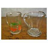 2 Pitchers 7 Inches Tall. Orange Pitcher Is Crackd