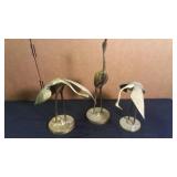 3 brass cranes,