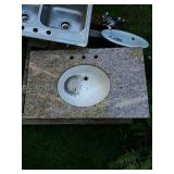 Granite counter top with recessed sink.