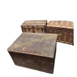 Two antique steamer trunks in a storage locker