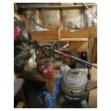 Contents of corner: table, shop vac, weed trimmer,