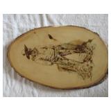 Pyrography on log of cowboy by Branson