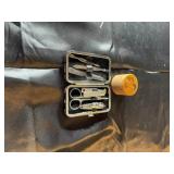Manicure set with small trinket, has crack on lid