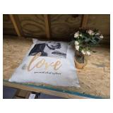 Love dog pillow and a flower arrangement