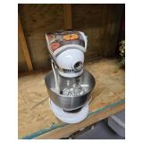A kitchen aid mixer with attachments