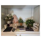 Contents of shelf, including rabbit figure,