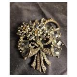 Black and crystal broach