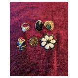 5 rings and owl pin