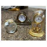 Little decorative clocks and a tiny apple