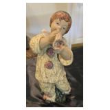 A porcelain clown playing instrument, 12 inches