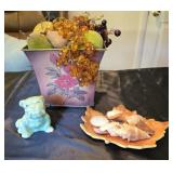 Vase with fruit and a leaf dish and green dog