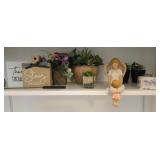 Contents of shelf: flowers, lamp, angel figurine,