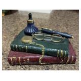 Decorative books with glasses, etc
