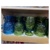 Shelf of blue and green glassware and more