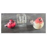 Two pretty red birds and a candleholder
