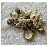 Elegant clock and pearl broach