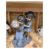 Boy and girl solar statue