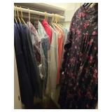 Double hanging closet full of sweatshirts and