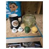 Black mug, salt and pepper shakers and a green