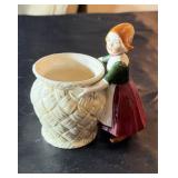 Small Amish girl carrying a pot, approximately