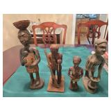Four hand carved figurines 6 to 10 inches tall