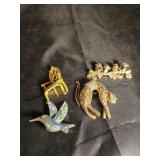 Chair, birds, leopard and hummingbird broach