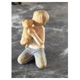 Willow tree figurine of boy holding dog