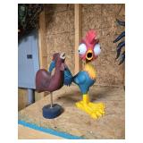 A rubber chicken and chicken on stand