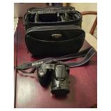 Nikon camera with case and a small Nikon camera