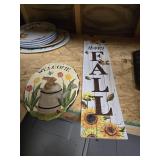 A fall plaque and a bunny welcome sign
