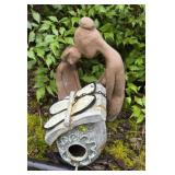 Bird house and man and woman statue
